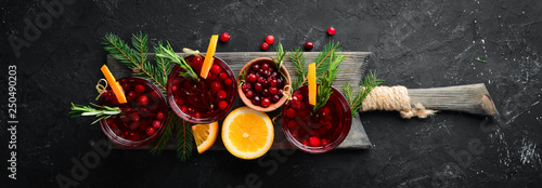 Fototapeta Naklejka Na Ścianę i Meble -  Glasses with cranberry juice. Cranberries, limes, rosemary. On a rustic background. Top view. Free space for your text.