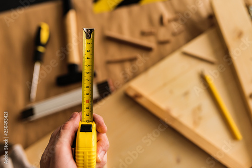 Carpenter with tape measure tool