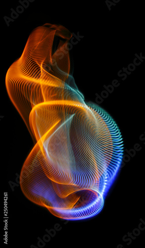 Multicolored twisted ordered parallel lines on a black background. Light in motion. Color abstraction.