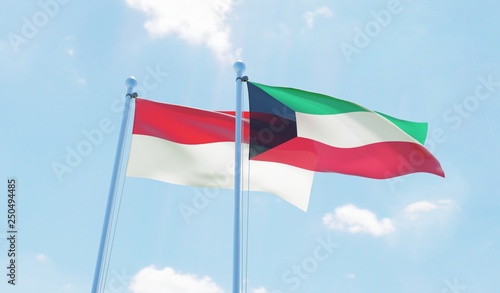 Kuwait and Indonesia, two flags waving against blue sky. 3d image