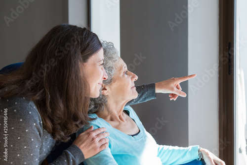 Adult daughter visiting elderly mother photo