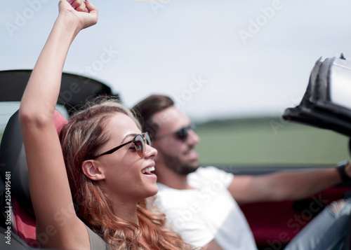 close up.a young woman with her boyfriend in a convertible car