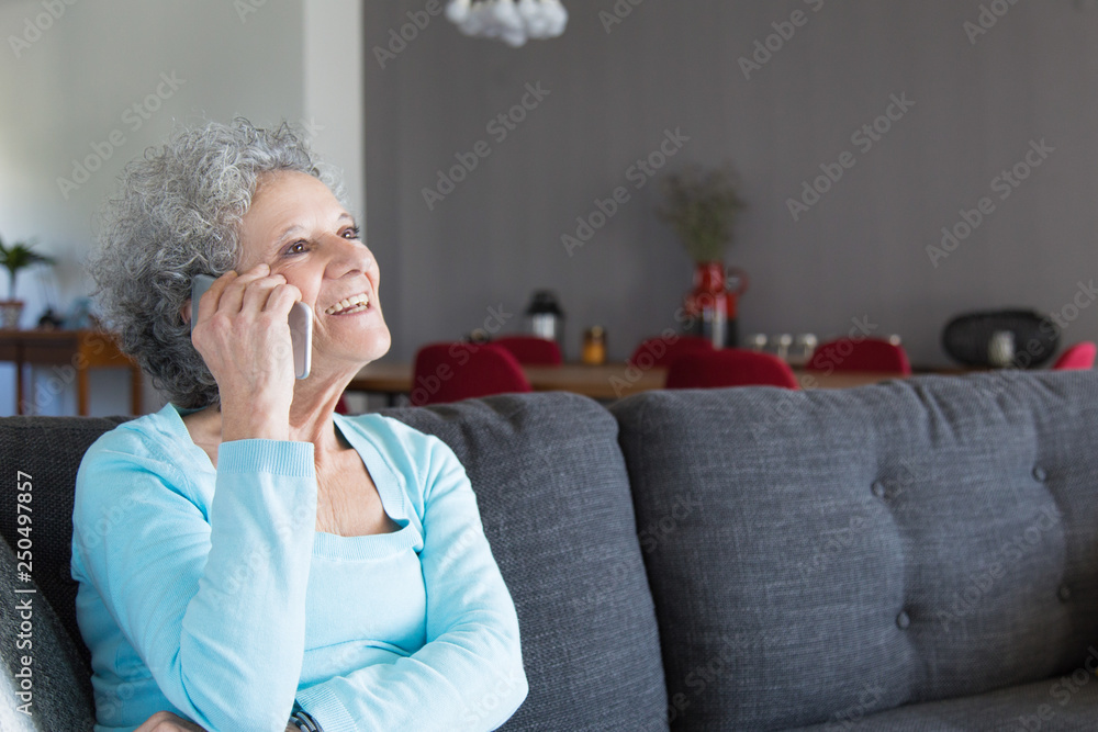Portrait of positive elderly woman talking on mobile phone Portrait of positive elderly woman talking on mobile phone