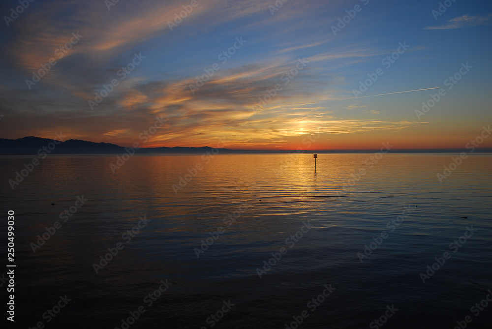 Lindau, Germany: A view of the Bodensee (aka Lake Constance), in the distance Austria, and Switzerland, at sunset in the summer Lindau, Germany: A view of the Bodensee (aka Lake Constance), in the distance Austria, and Switzerland, at sunset in the summer