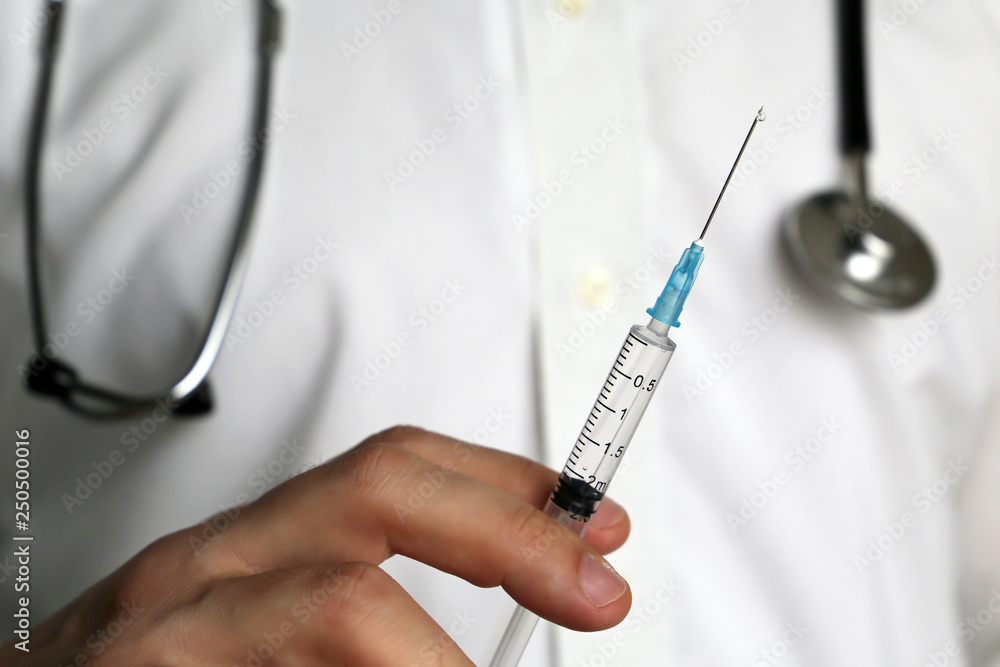 Doctor with syringe preparing to injection. Concept of vaccination, treatment in clinic, plastic surgery Doctor with syringe preparing to injection. Concept of vaccination, treatment in clinic, plastic surgery