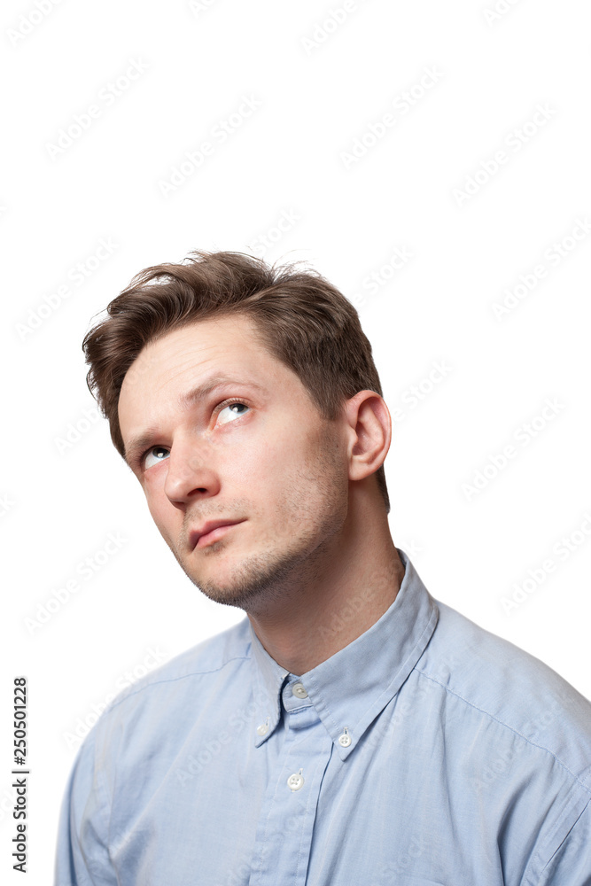 Thinking man isolated on white background. Closeup portrait of a casual young pensive businessman looking up at copyspace. Thinking man isolated on white background. Closeup portrait of a casual young pensive businessman looking up at copyspace.