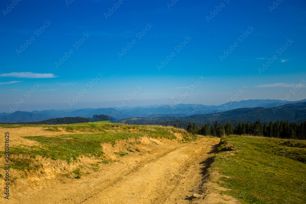 Beautiful landscape of summer mountains with blue sky. Autumn mountain village panoramic landscape Beautiful landscape of summer mountains with blue sky. Autumn mountain village panoramic landscape