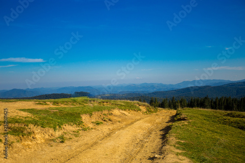 Beautiful landscape of summer mountains with blue sky. Autumn mountain village panoramic landscape