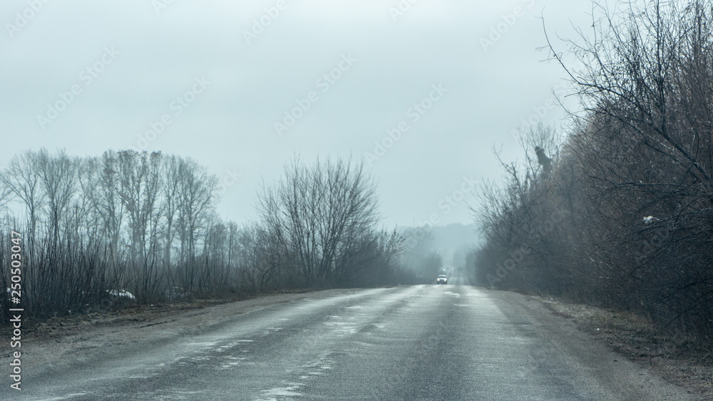 Morning country road in early spring with a haze on the horizon Morning country road in early spring with a haze on the horizon