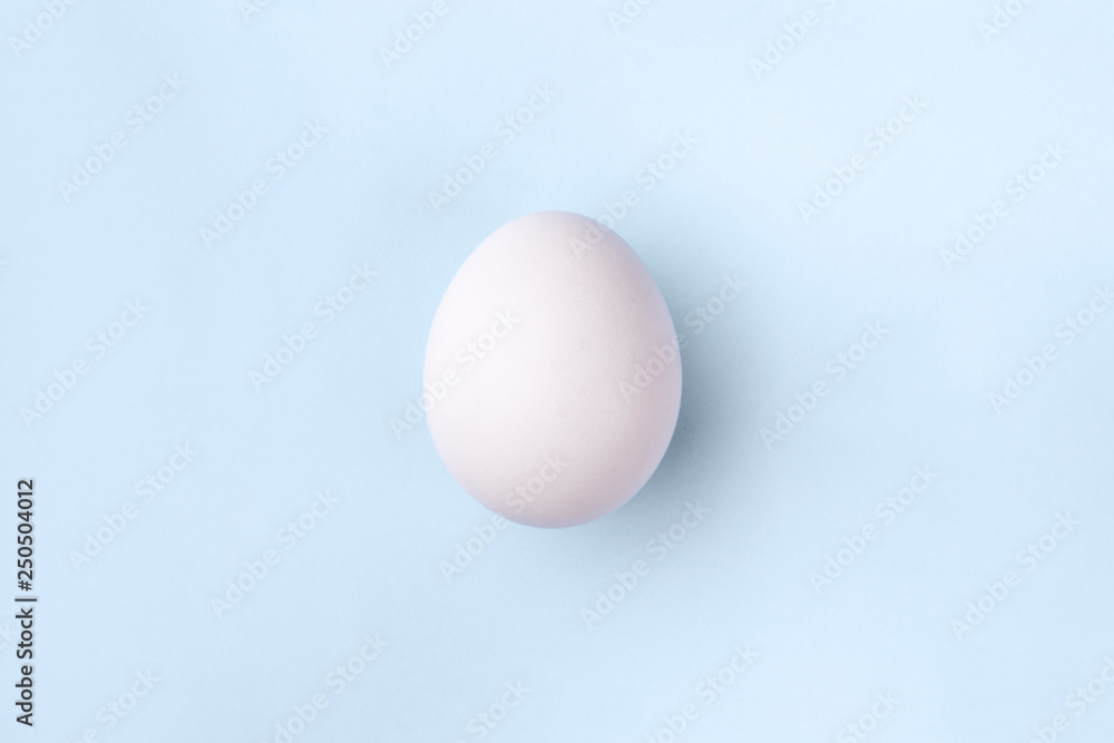 white egg on pastel blue background, concept Happy Easter white egg on pastel blue background, concept Happy Easter