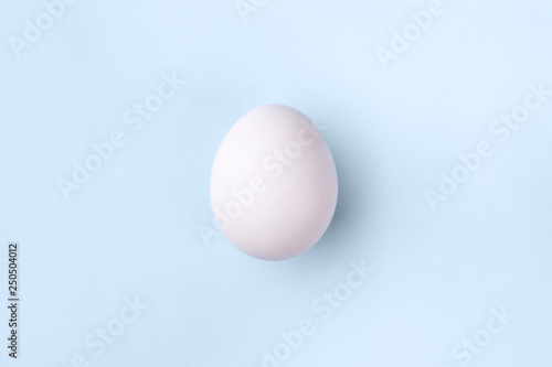 white egg on pastel blue background, concept Happy Easter