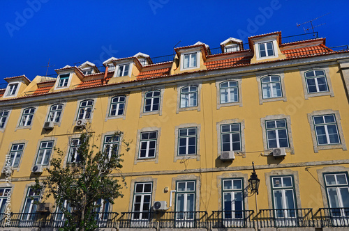A large yellow house with balconies in Lisbon