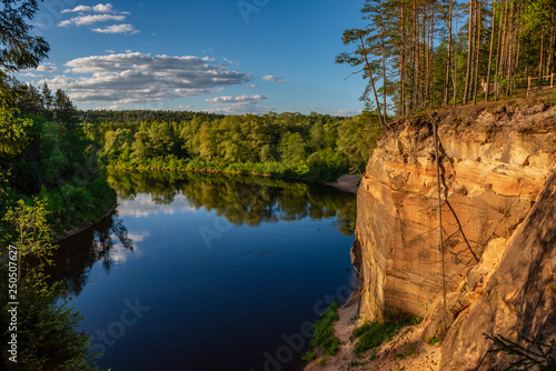 sandstone cliffs on the shore of forest river