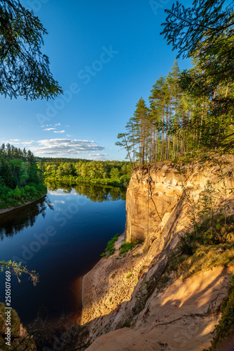Fototapeta Naklejka Na Ścianę i Meble -  sandstone cliffs on the shore of forest river