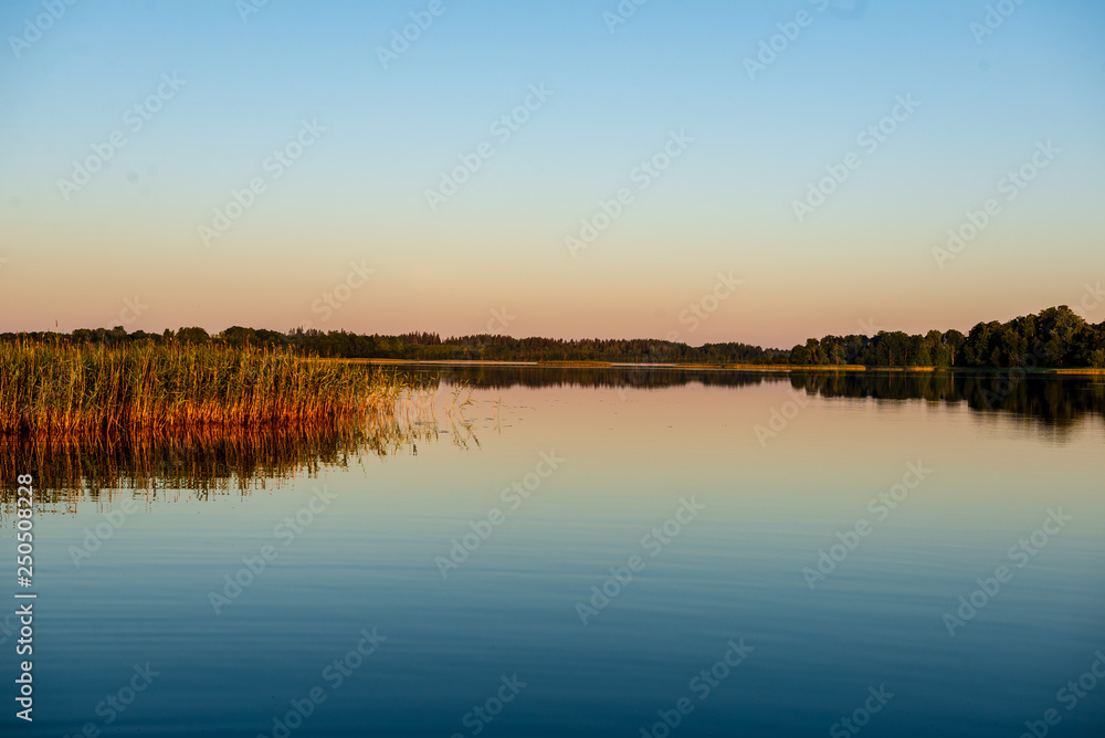 Fototapeta premium calm weather sunset on country lake