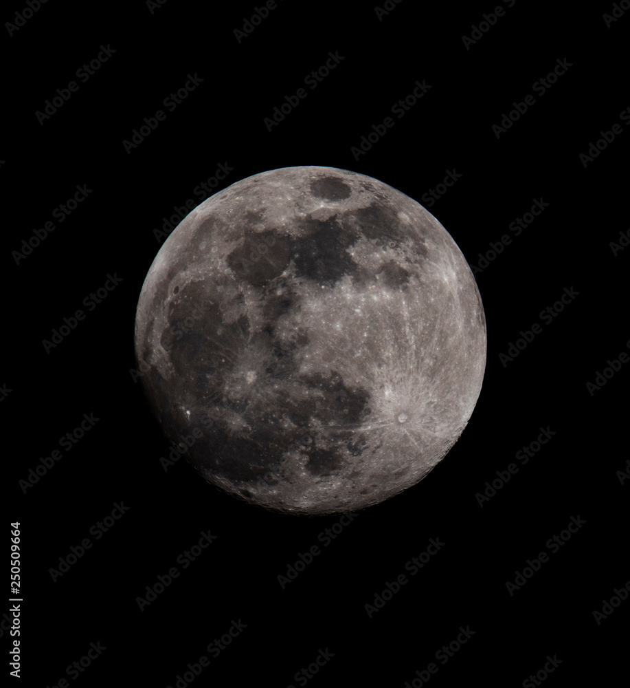 Super close up of full moon shot during Snow Moon in February 2019. Crater planet against dark night sky Super close up of full moon shot during Snow Moon in February 2019. Crater planet against dark night sky