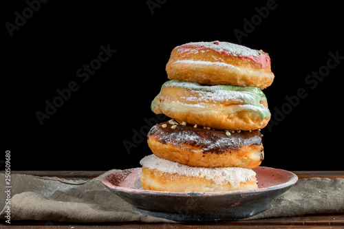 A stack of two donuts on black background.