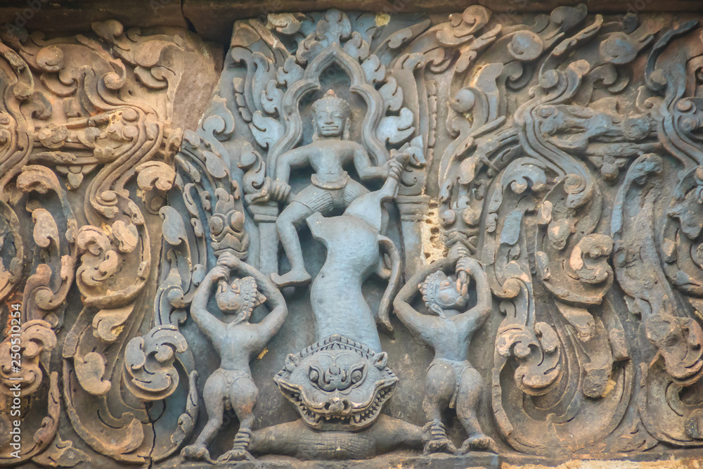 Beautiful sandstone craved on the lintel, doorway and windows of Lord Krishna killing Lion in Bapuan Khmer art at Phra That Narai Cheng Weng, Sakon Nakhon, Thailand.