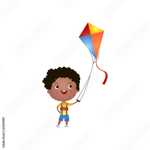 Smiling black boy with curly hair plays with kite isolated on white background