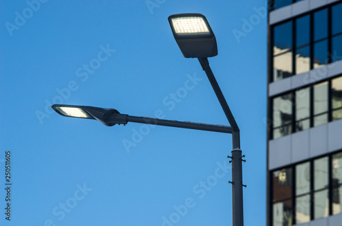 A modern street LED lighting pole. Urban electro-energy technologies. Savings on street urban road lighting.