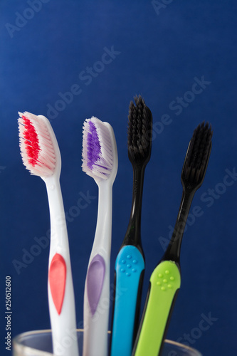 toothbrushes are multicolored on a bright blue background close-up