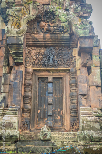Beautiful sandstone craved on the lintel, doorway and windows of Lord Krishna killing Lion in Bapuan Khmer art at Phra That Narai Cheng Weng, Sakon Nakhon, Thailand.
