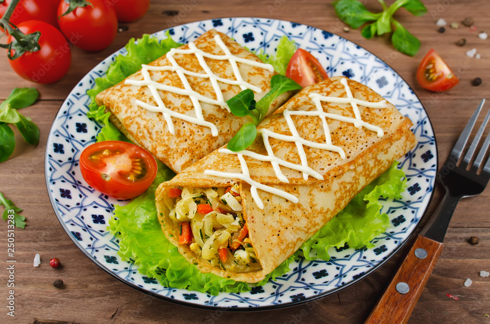 Crepes stuffed with stewed cabbage with carrots and eggs. Crepes stuffed with stewed cabbage with carrots and eggs.