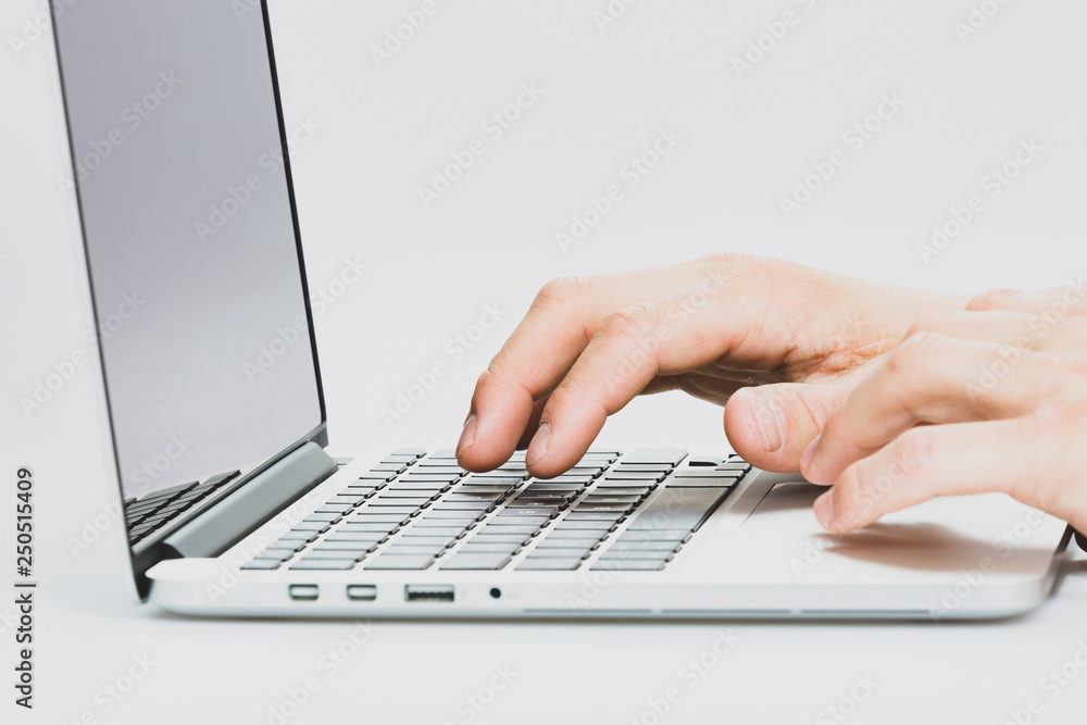 Hands are typing on a laptop. Light background. The man is writing on the keyboard. Personal computer. Tool for working in business, freelancers and more. Hands are typing on a laptop. Light background. The man is writing on the keyboard. Personal computer. Tool for working in business, freelancers and more.