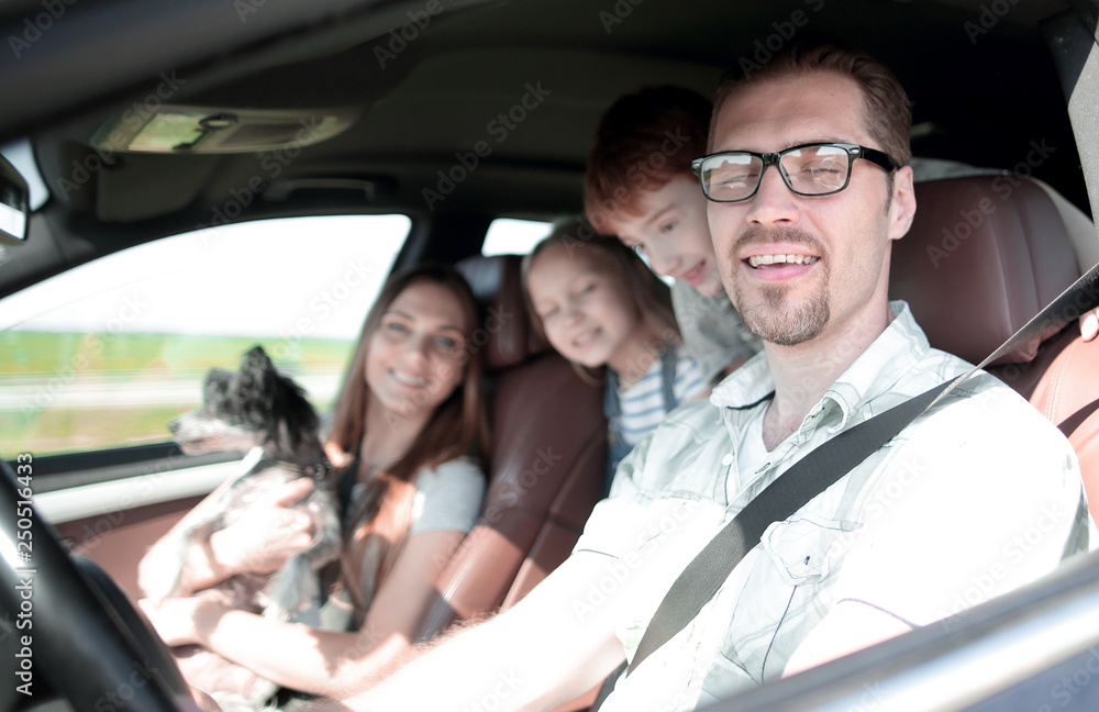 side view.happy father driving a family car side view.happy father driving a family car