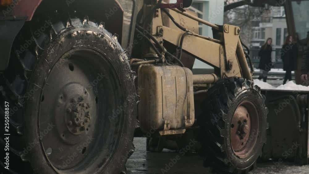 Tractor getting ready to work in the town square. Slow motion. 4k Tractor getting ready to work in the town square. Slow motion. 4k