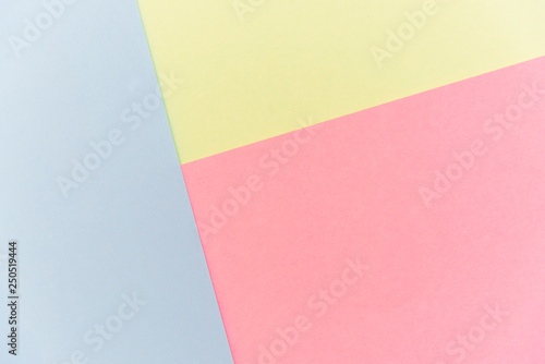 Blue, pink and yellow pastel color paper geometric flat lay background