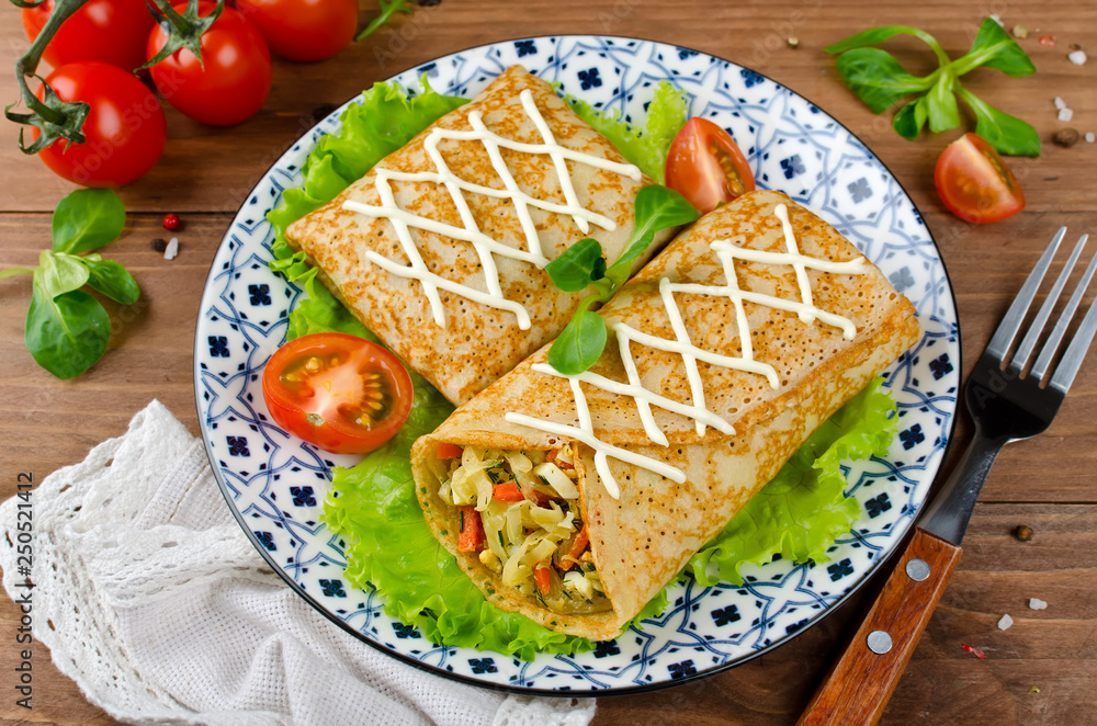Crepes stuffed with stewed cabbage with carrots and eggs. Crepes stuffed with stewed cabbage with carrots and eggs.