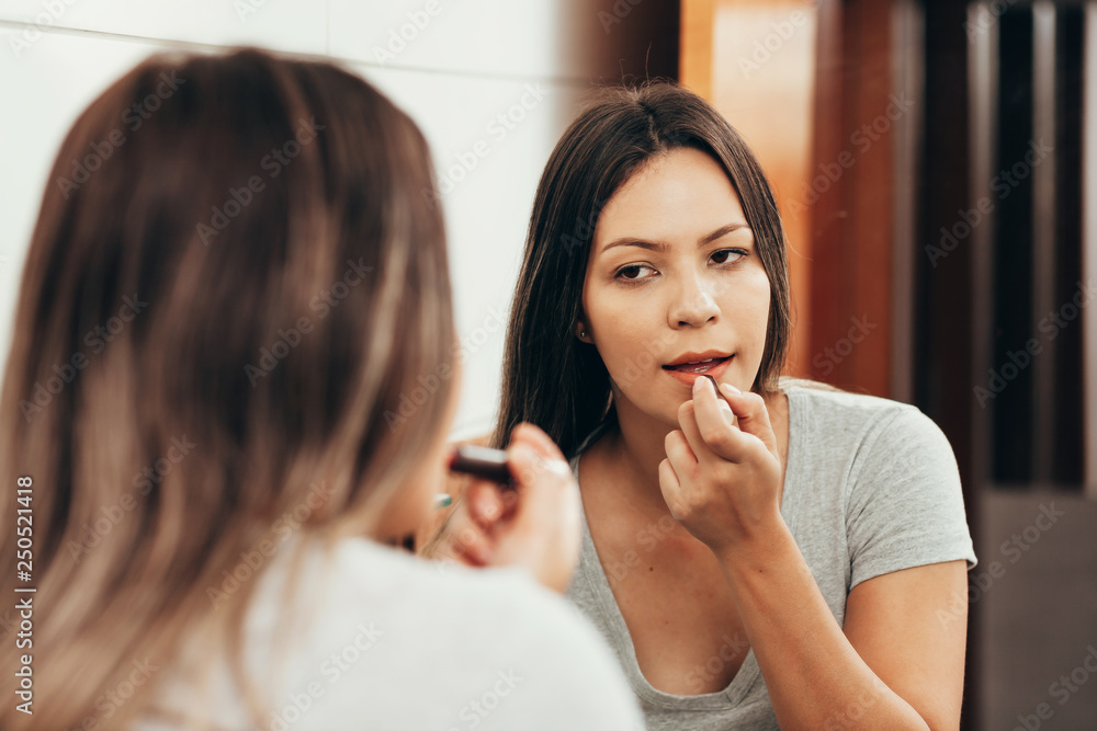 Woman make up. Woman making up with lipstick in front of mirror Woman make up. Woman making up with lipstick in front of mirror