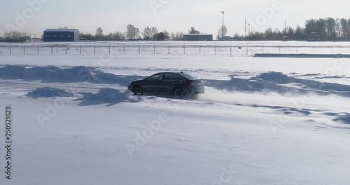 Blue and black subaru wrx racing on the ice ring, aerial view