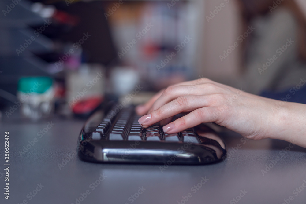 Woman's hands typing on computer keyboard, close up shot Woman's hands typing on computer keyboard, close up shot