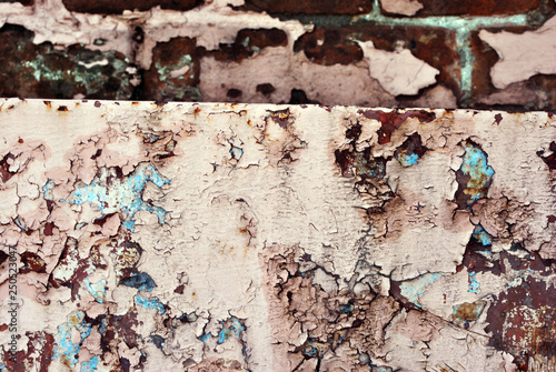 Rusty cracked pink-yellow paint surface with turquoise details close up  grunge horizontal shabby background