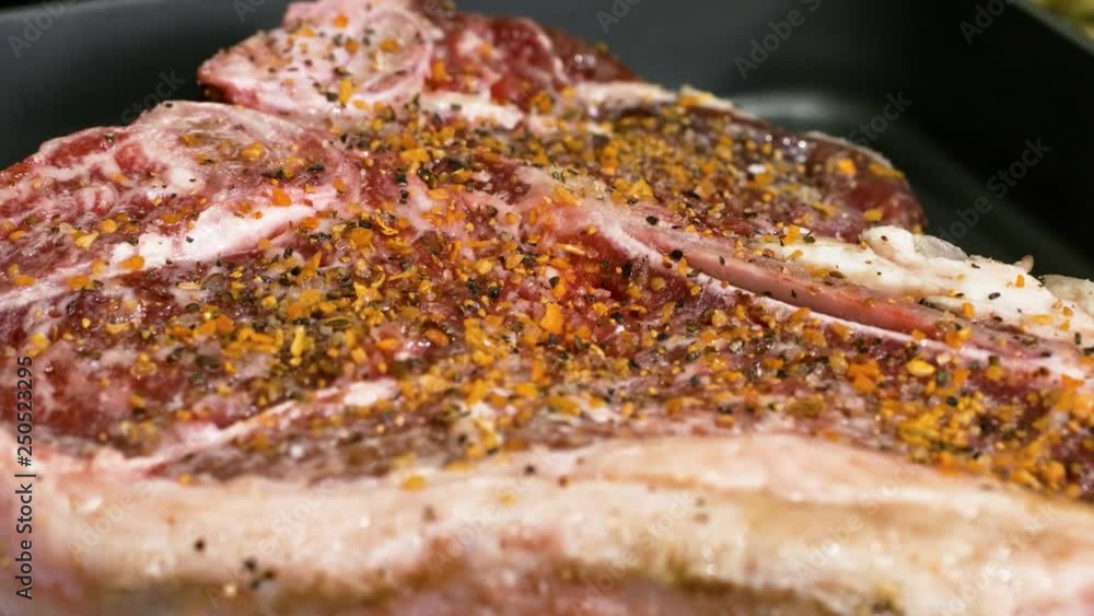 Close up shot showing a half cooked fresh steak frying to a crisp on a frying pan. Close up shot showing a half cooked fresh steak frying to a crisp on a frying pan.