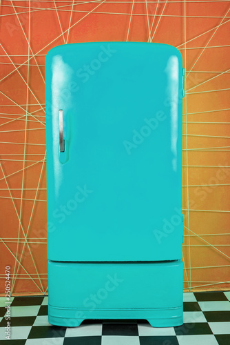 old vintage blue refrigerator on a orange background