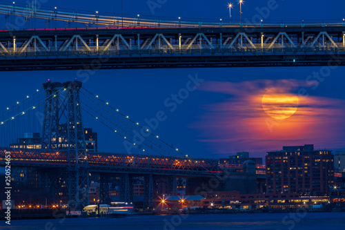 View to moonrise over Williamsburg Bridge from Manhattan.