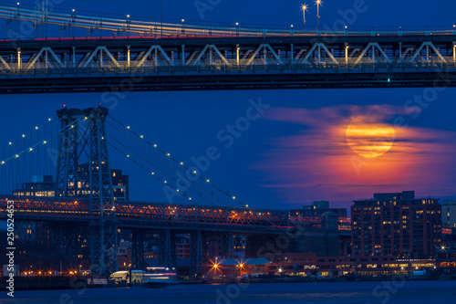 Photography View to moonrise over Williamsburg Bridge from Manhattan.