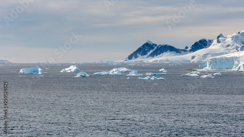 View of ice mountains and icebergs on bay in Antarctica