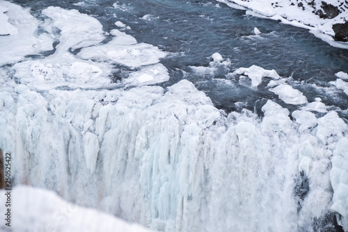 Icelandic Iceland waterfall frozen and covered in snow during winter