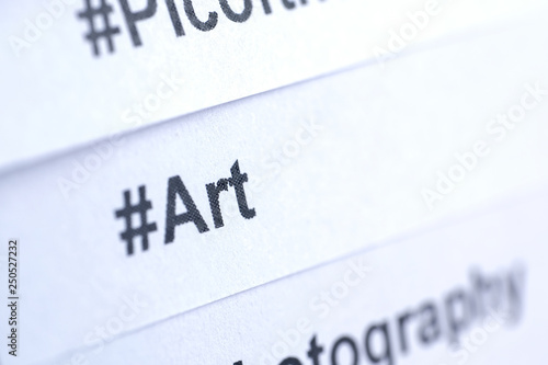 Popular hashtag 'art' printed on white paper. Close up.