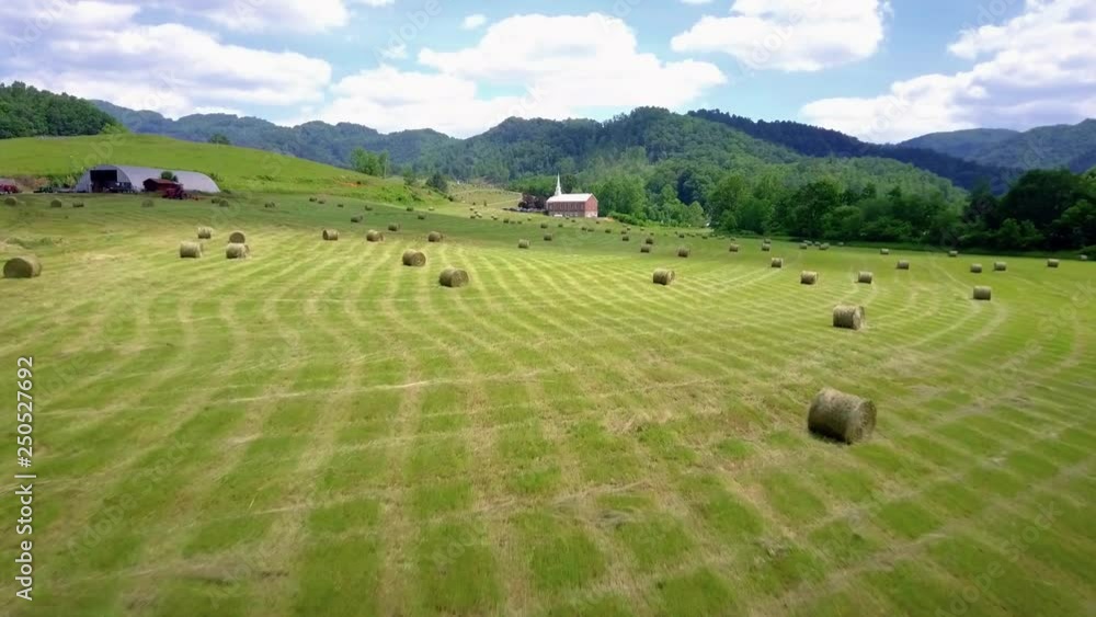 Hay Farm beginning its cultivation of the season with the Smoky Mountains as a backdrop.