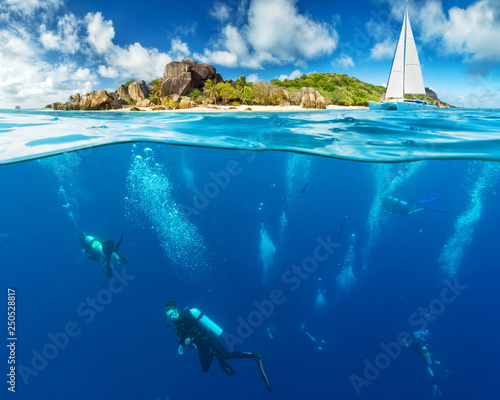 Obraz na plátně Under and above water surface view of divers.