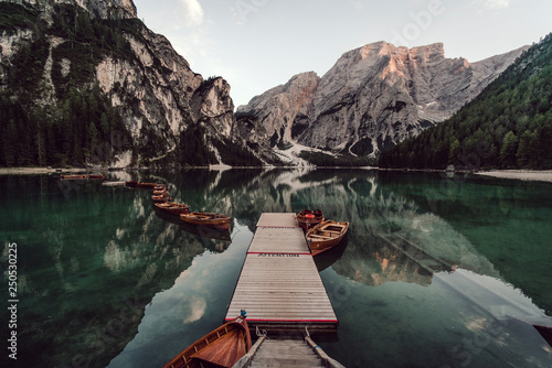Rowboats moored in lake against mountains range photo