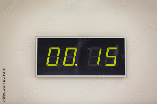 Black digital clock on a white background showing time 00.15 minutes photo