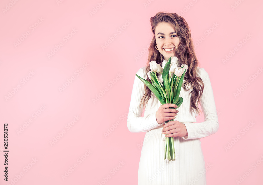 Young girl with tulips on a colored background Young girl with tulips on a colored background