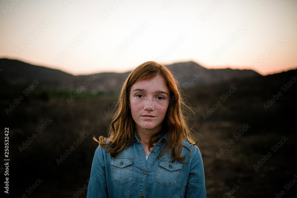 Portrait of girl standing on field against sky during sunset Portrait of girl standing on field against sky during sunset