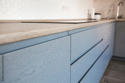 Blue and white cabinets in modern kitchen interior